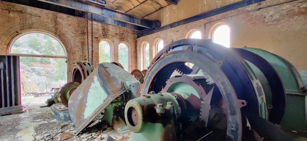 A large power generator in a brick building, part of the abandoned Skagway Powerplant in Colorado