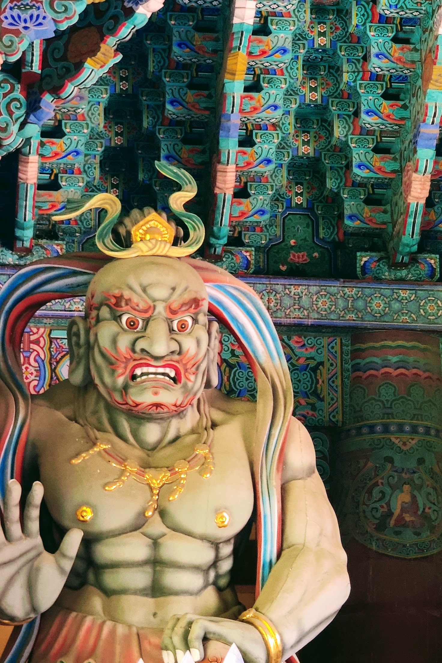 A close up image of a buddhist god known as one of the heavenly kings