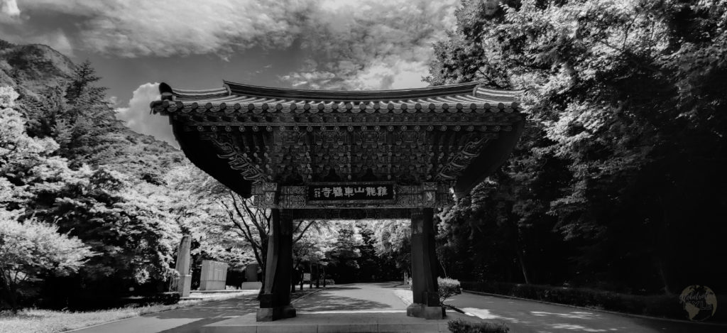 A black and white one pillar gate to a buddhist temple in south korea