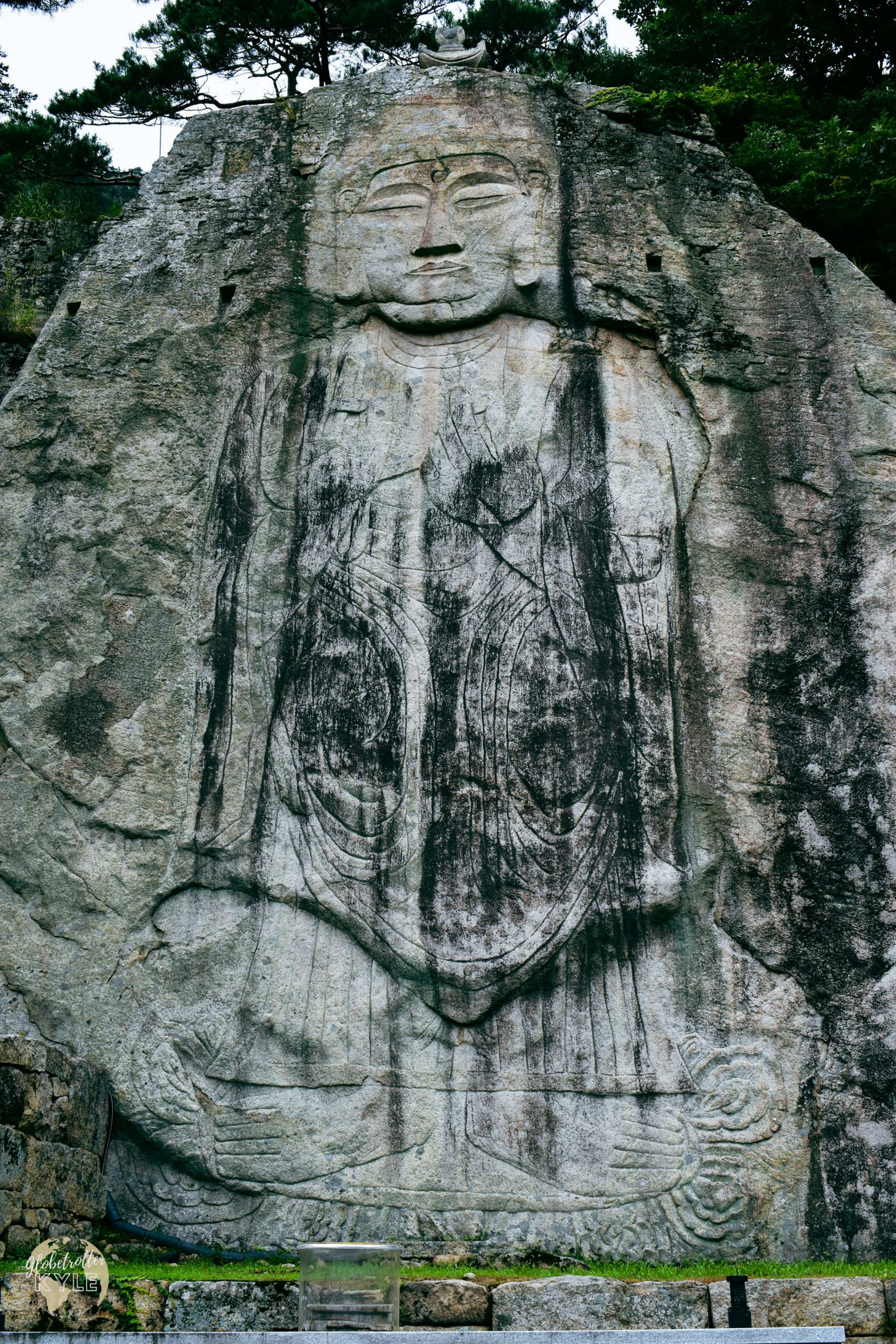 a 13-meter tall buddha carved into the side of a mountain dating back to the 10th century 