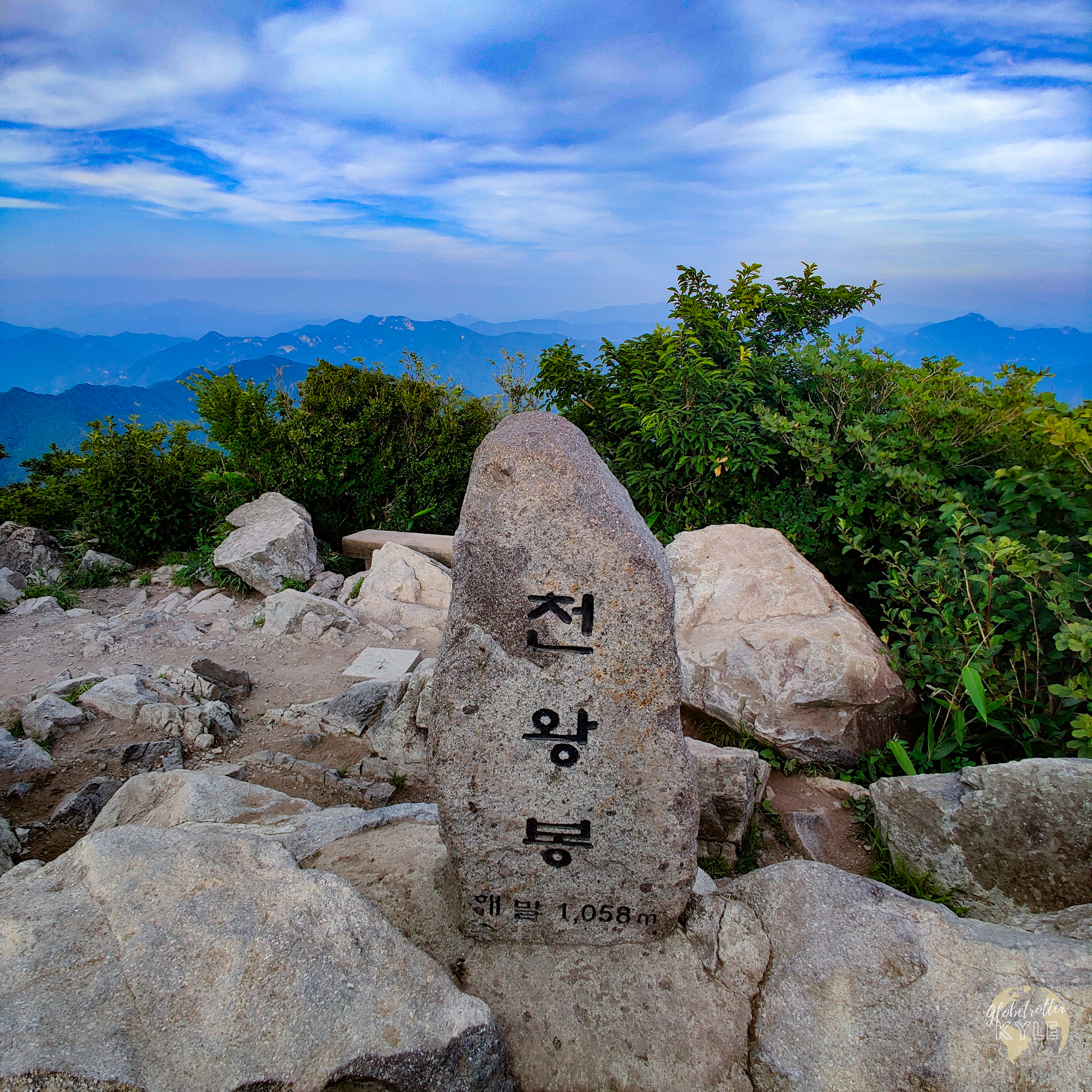 an engraved boulder on top of a korean mountain in south korea