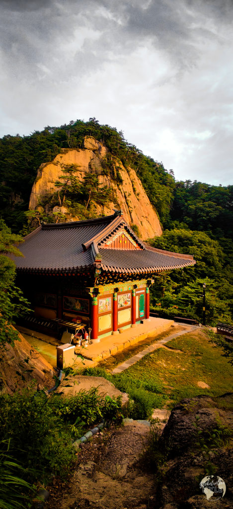 a buddhist temple (Sanggoam) reflects light from the sun as it sets 