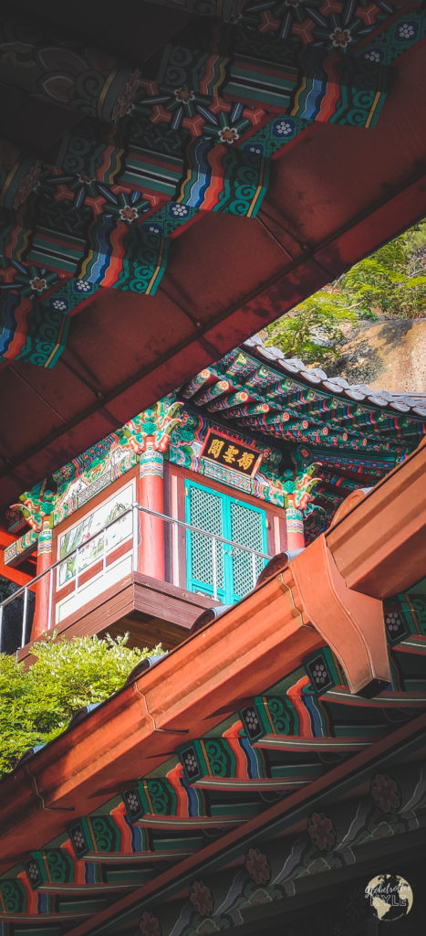 a temple hut photographed uniquely placed between two other temple roofs in the foreground