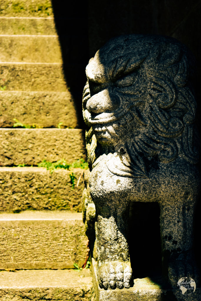 an up-close carved, stone lion on a staircase at Byeongpungam Seokbulsa Temple