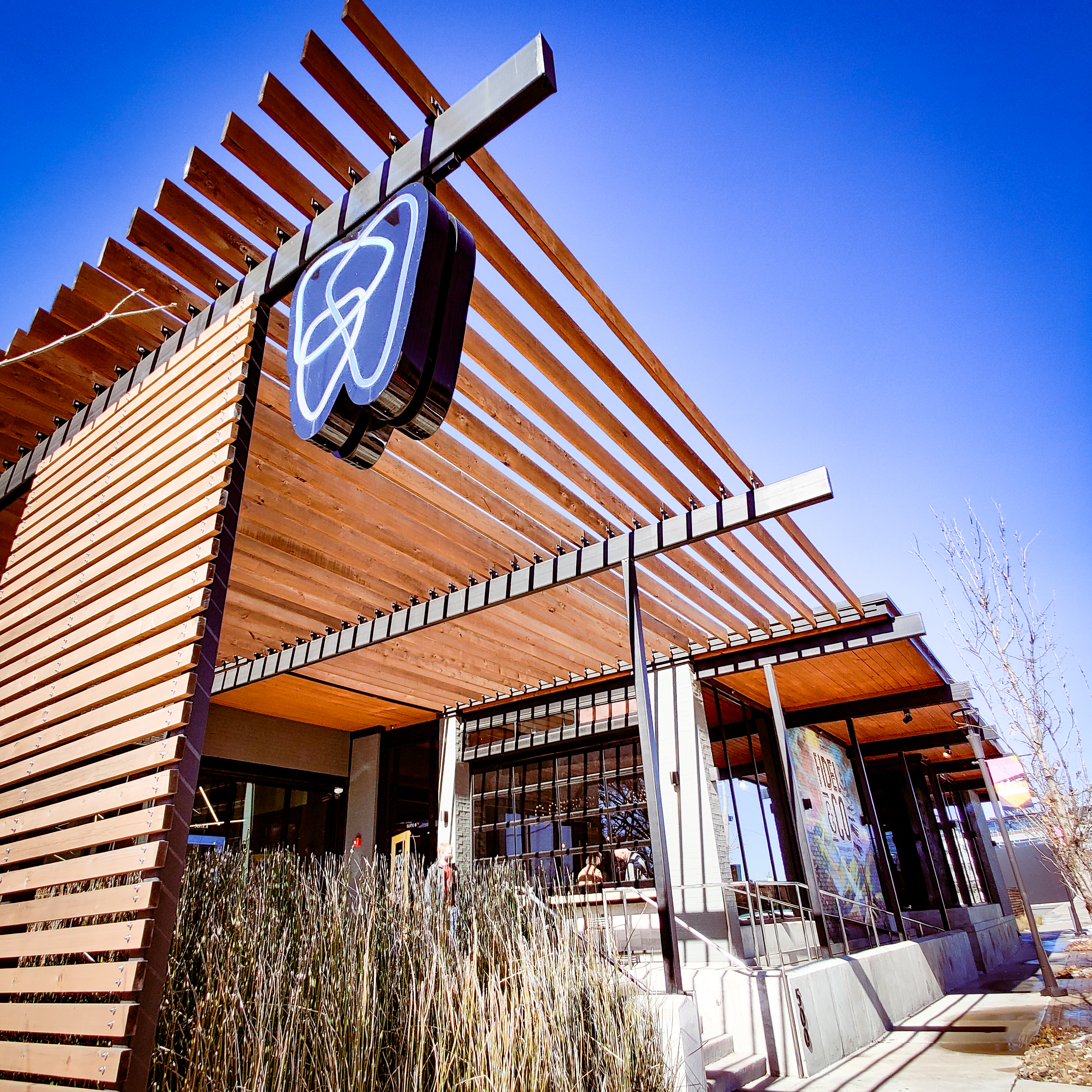 a modern building with a wood-slatted façade and roof awning for Fidel & Co coffee roasters in Little Rock Arkansas