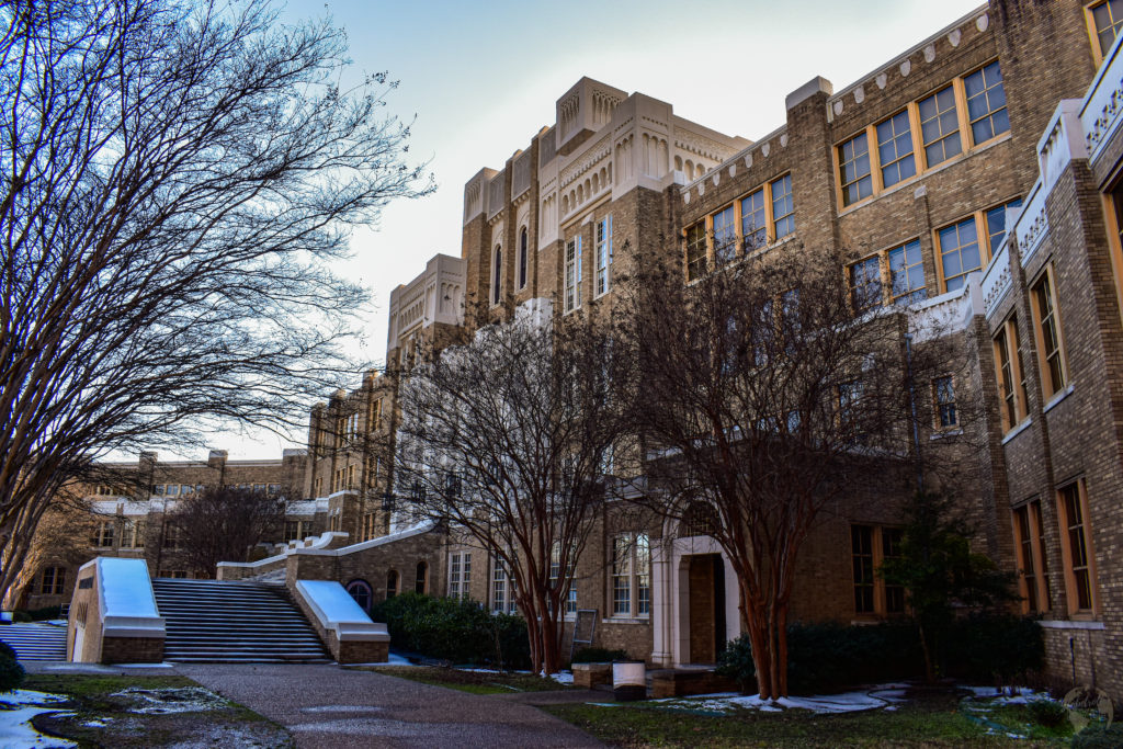 Little Rock Central high School historic site an old historic brick building with trees and snow in foreground