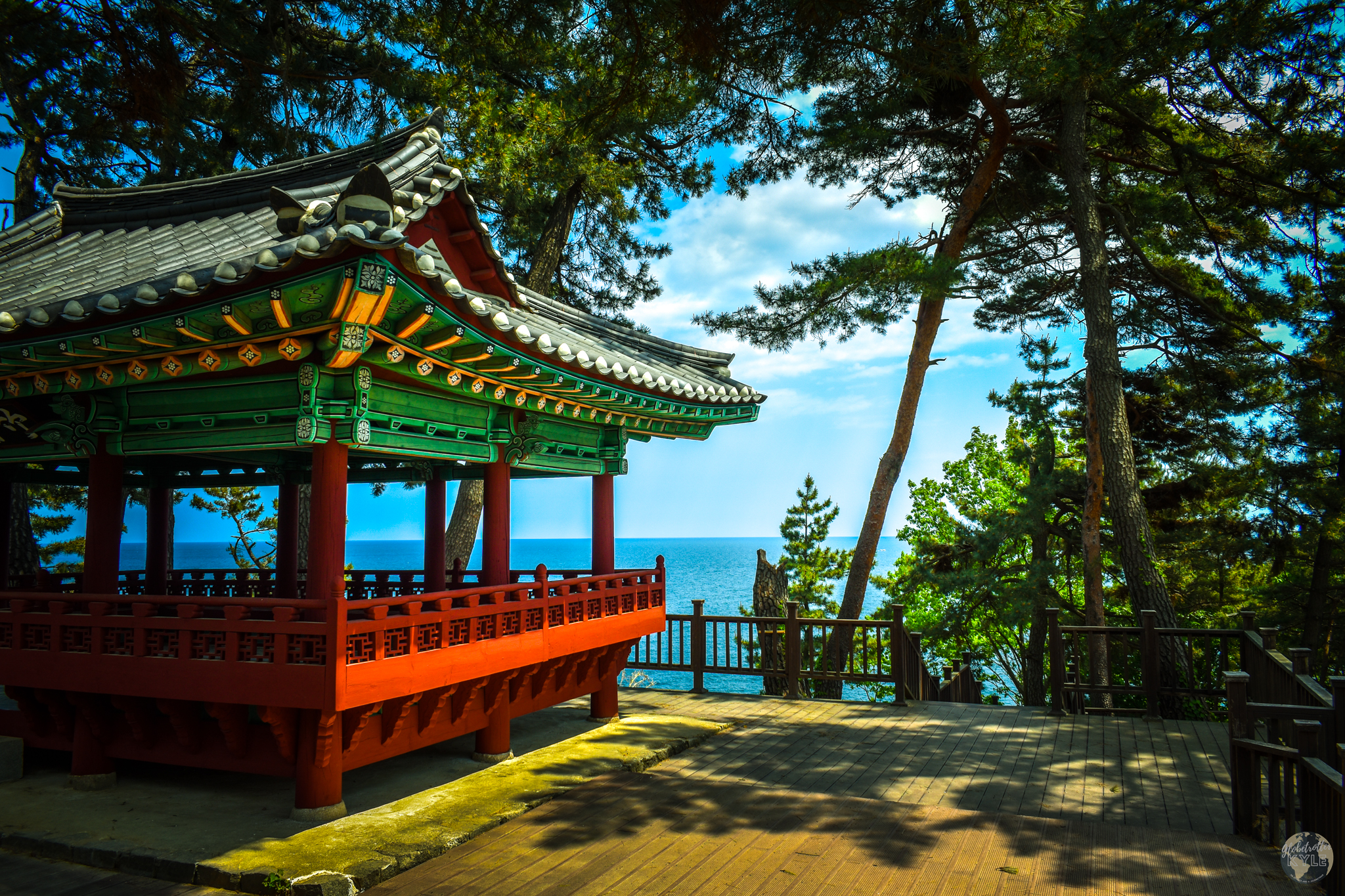The brightly colored Jugdojeong Pavilion Korean pavilion rests under tall pine trees with the ocean in the background Guide for Sokcho and Seoraksan