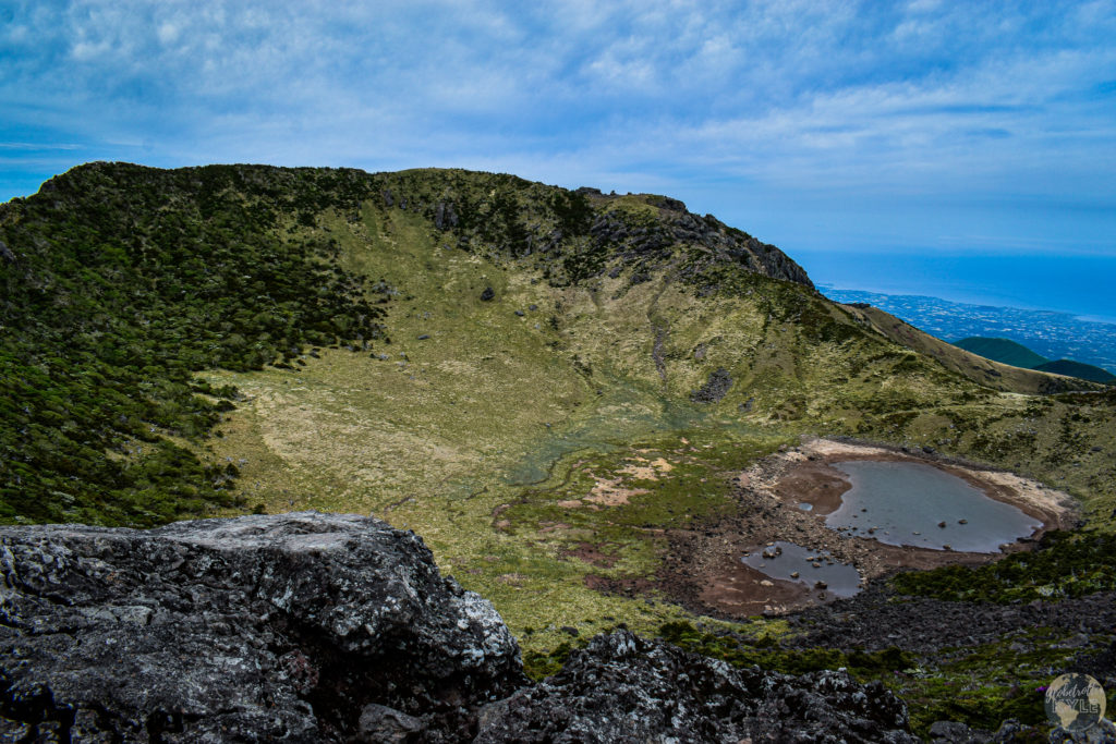 a crater on top of a volcano on Jeju Island in South Korea seen when doing South Korea Hiking