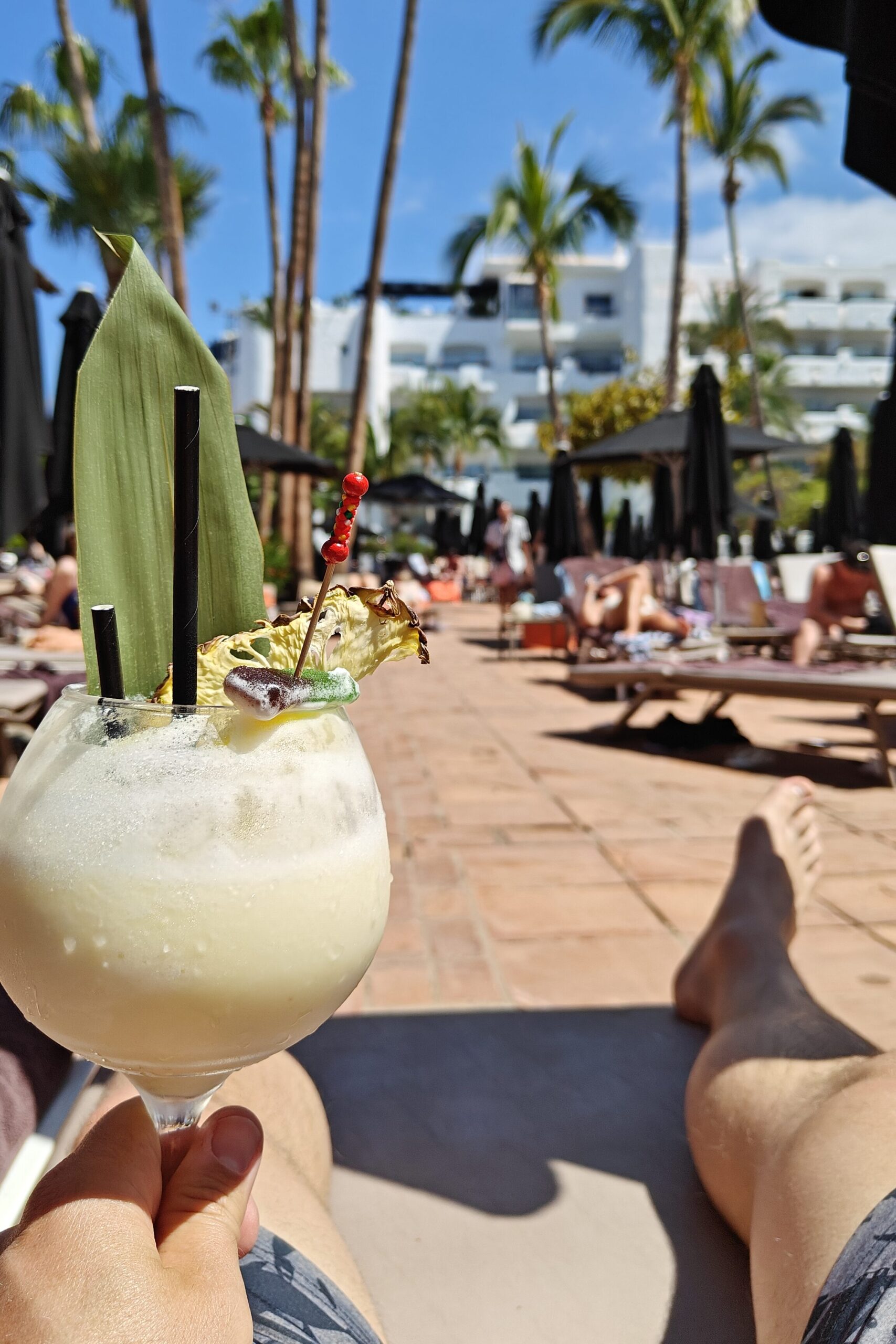 A person holding a drink, one of the many what to do in Tenerife items