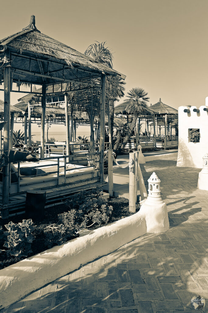 A walkway with a thatched roof at  Dreams Jardin Tropical Resort & Spa in Costa Adeje. 