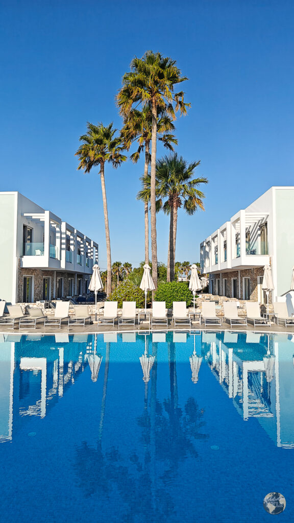 palm trees reflect on a resort pool on the island of Kos Greece