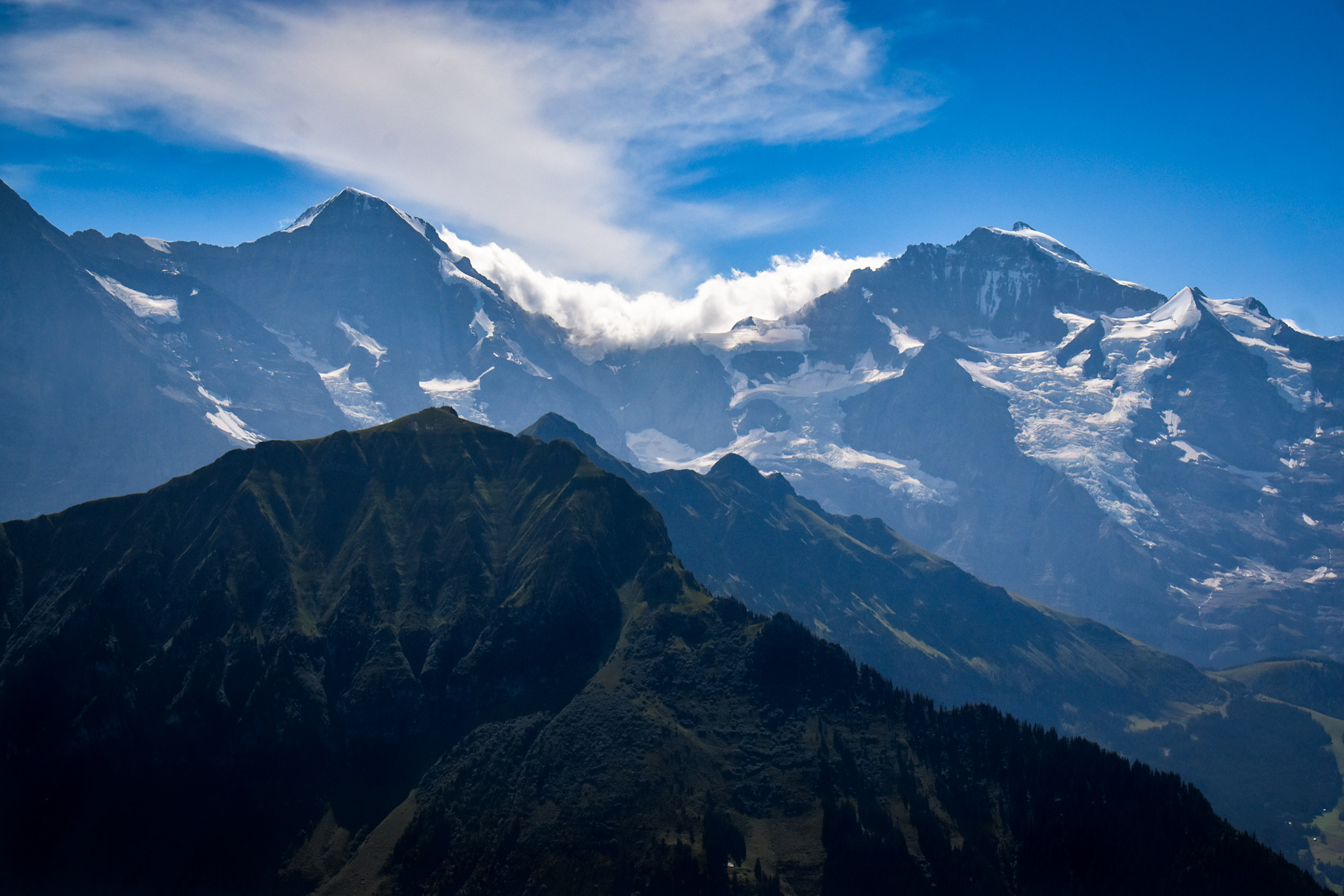 clouds rolling over Eiger and Jungfrau mountains in the Swiss Alps