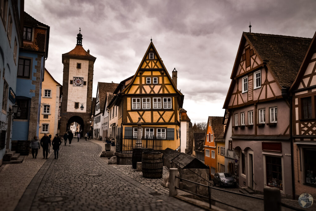 The Plönlein in Rothenburg ob der Tauber A street with buildings and people walking on it