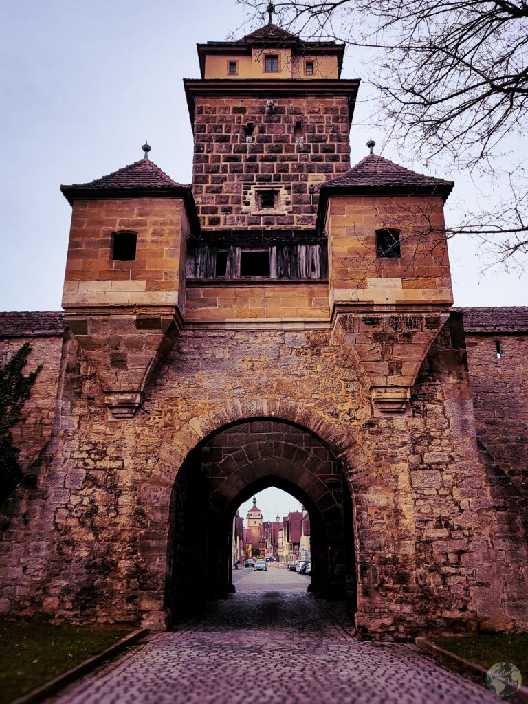 A stone archway with a tower
 in Rothenburg ob der Tauber