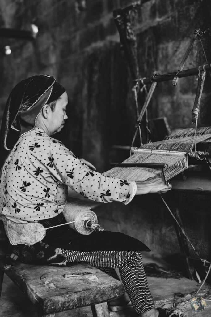 a vietnamese woman weaves hemp along the ha giang loop