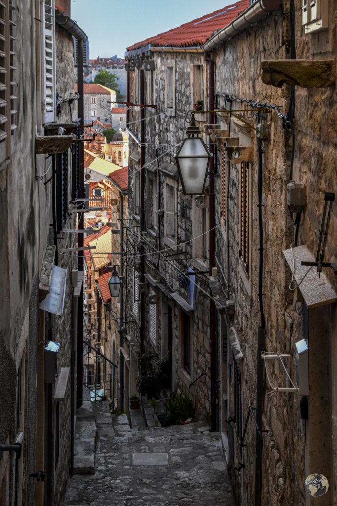 Stairs divide two close european old town buildings in Dubrovnik