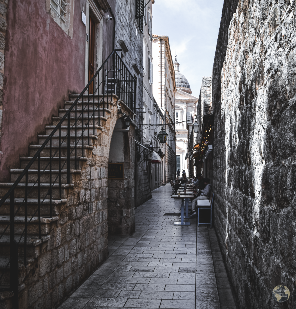 Old stone stairs run along a city walkway in old town dubrovnik, a must do
