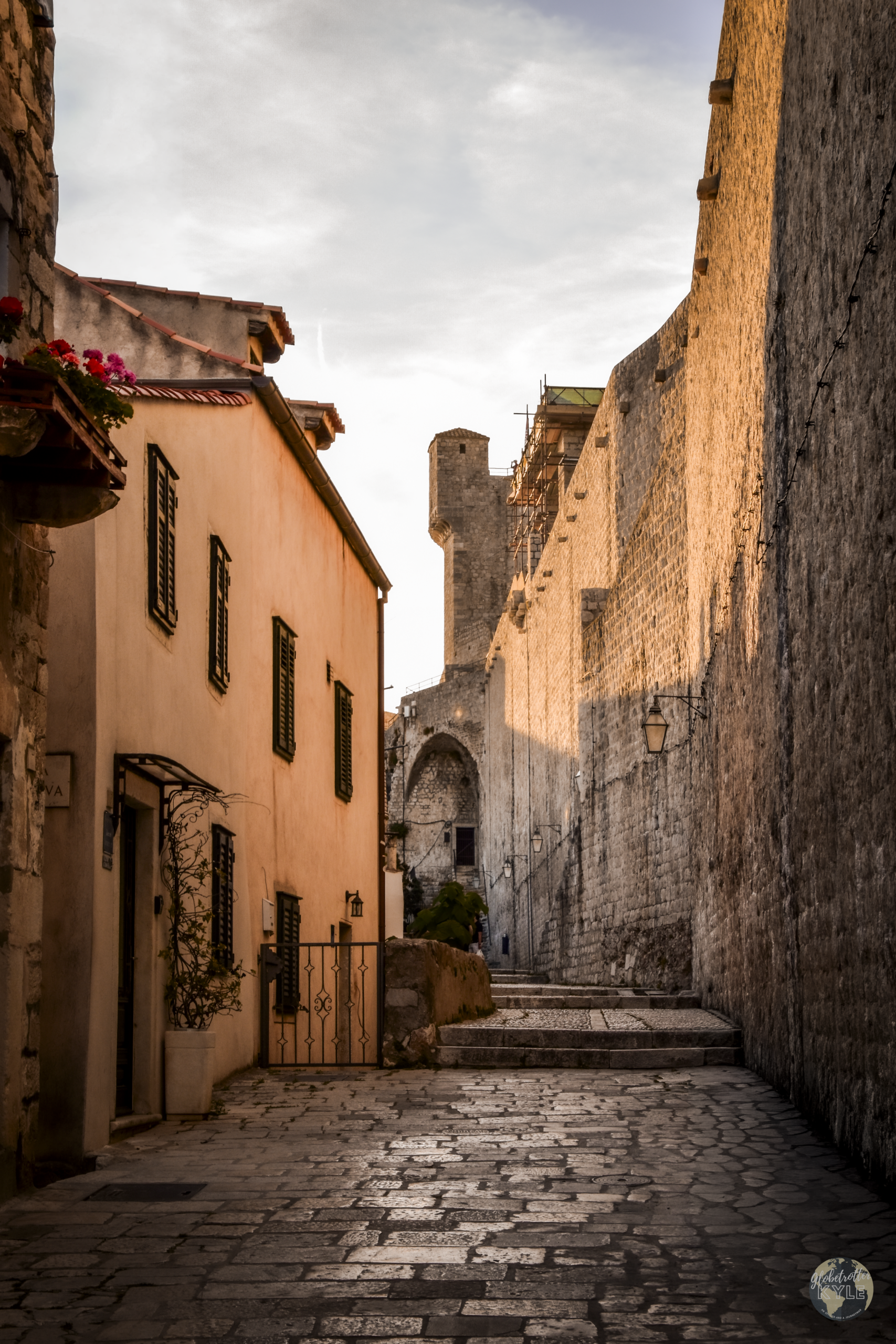 warm light reflects off the city walls surrounding Dubrovnik's old town, a must do in dubrovnik
